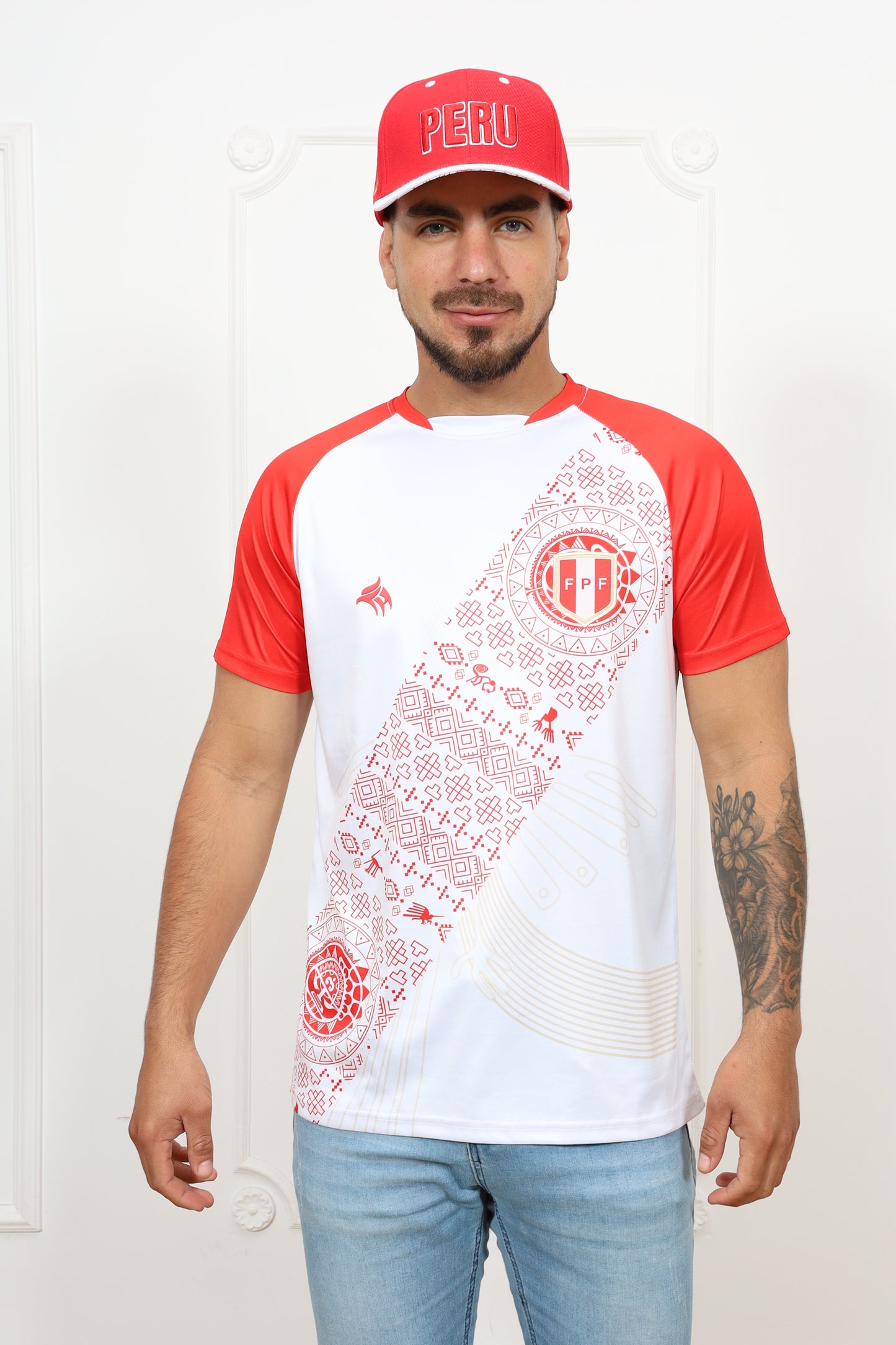 Person wearing a white and red baseball-style shirt with graphics, standing against a plain background.