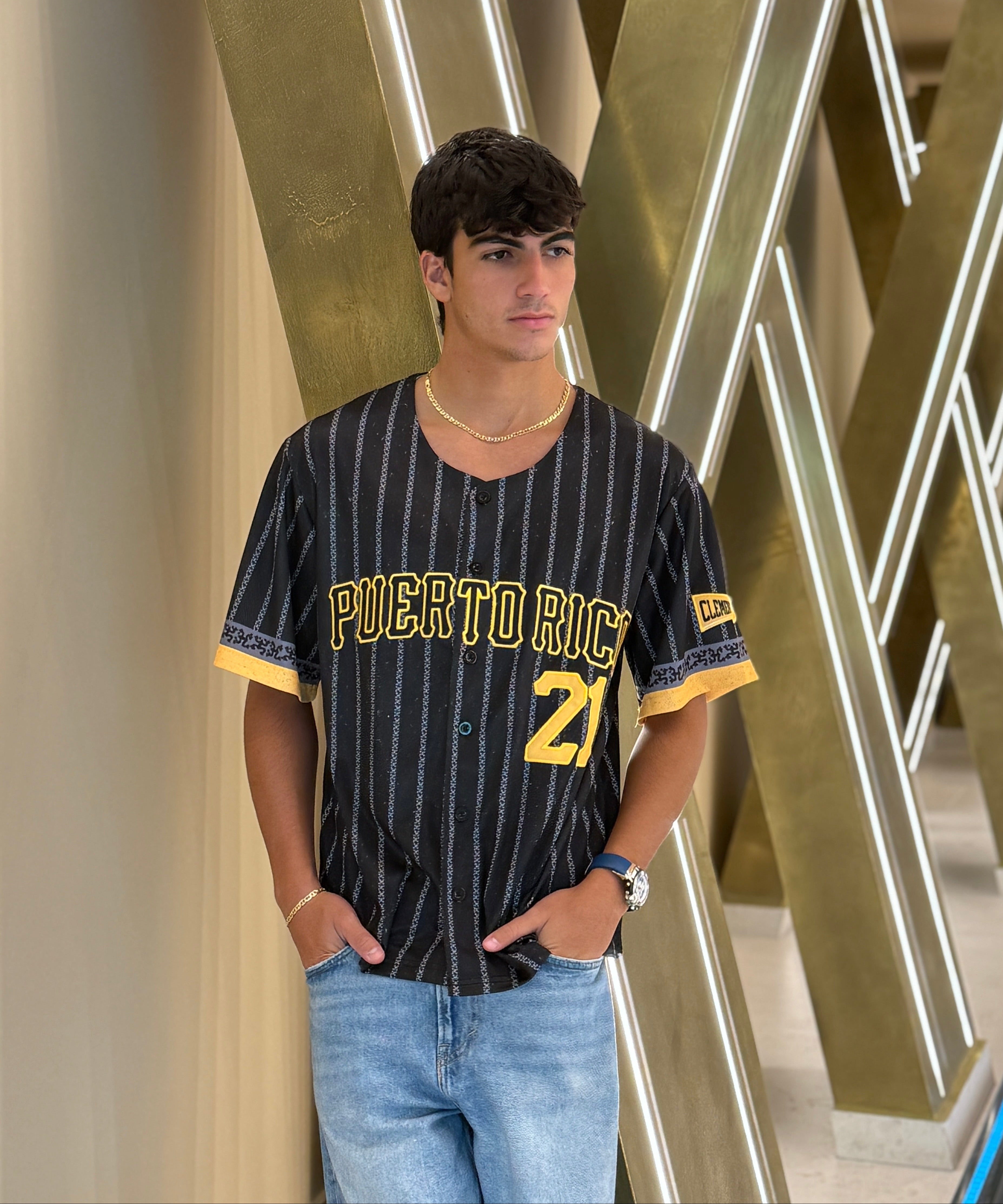 Person wearing a 'Puerto Rico' themed jersey with decorative wall in the background