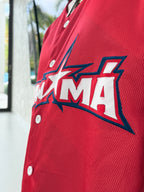 Close-up of a red canopy with a logo on a vehicle, featuring the letters 'AMA'.