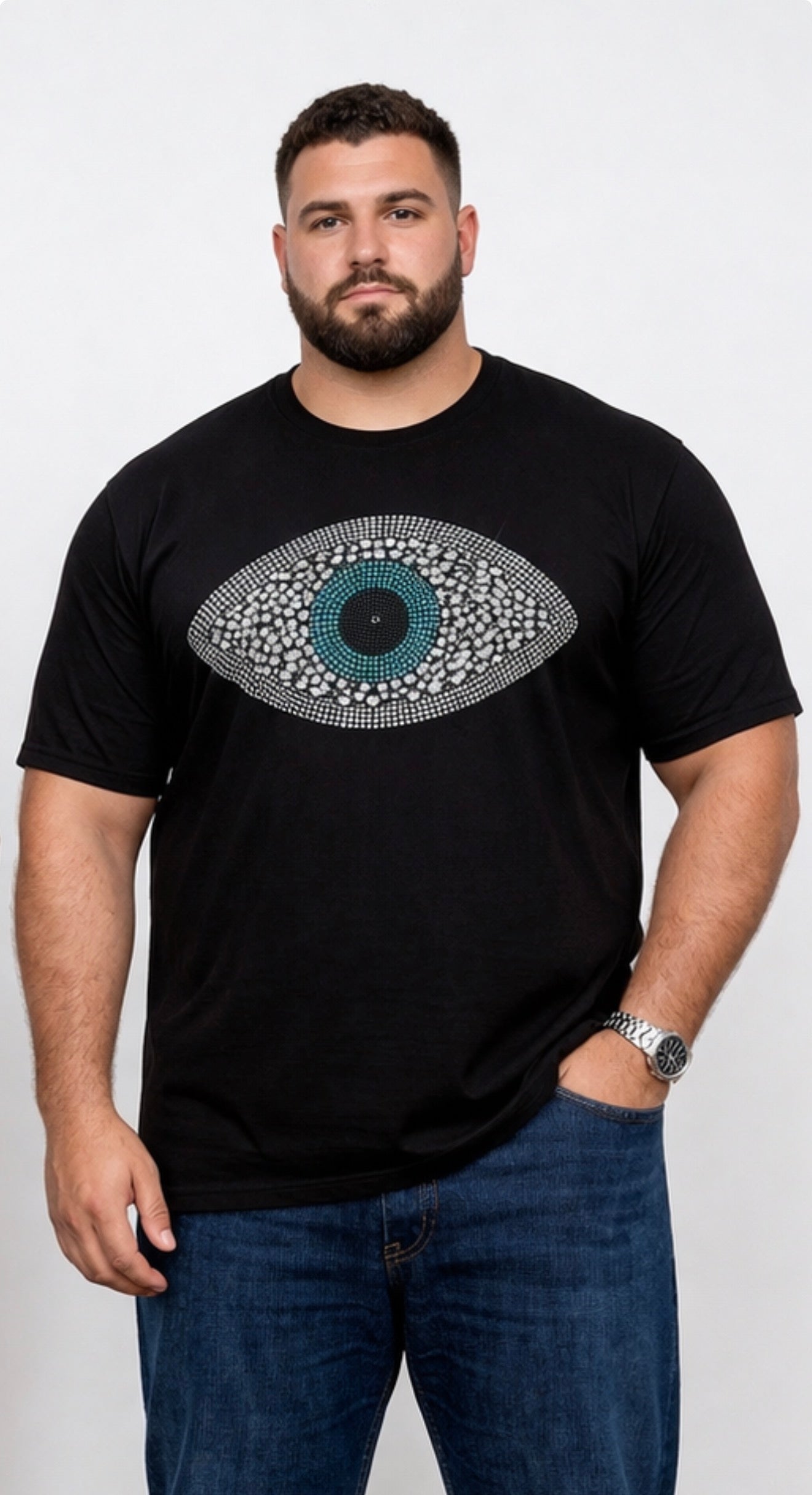 Man wearing a black t-shirt with a decorative eye design on a white background