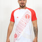Person wearing a white and red baseball-style shirt with graphics, standing against a plain background.