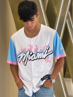 Person wearing a 'Miami' jersey with colorful sleeves on a metallic staircase.