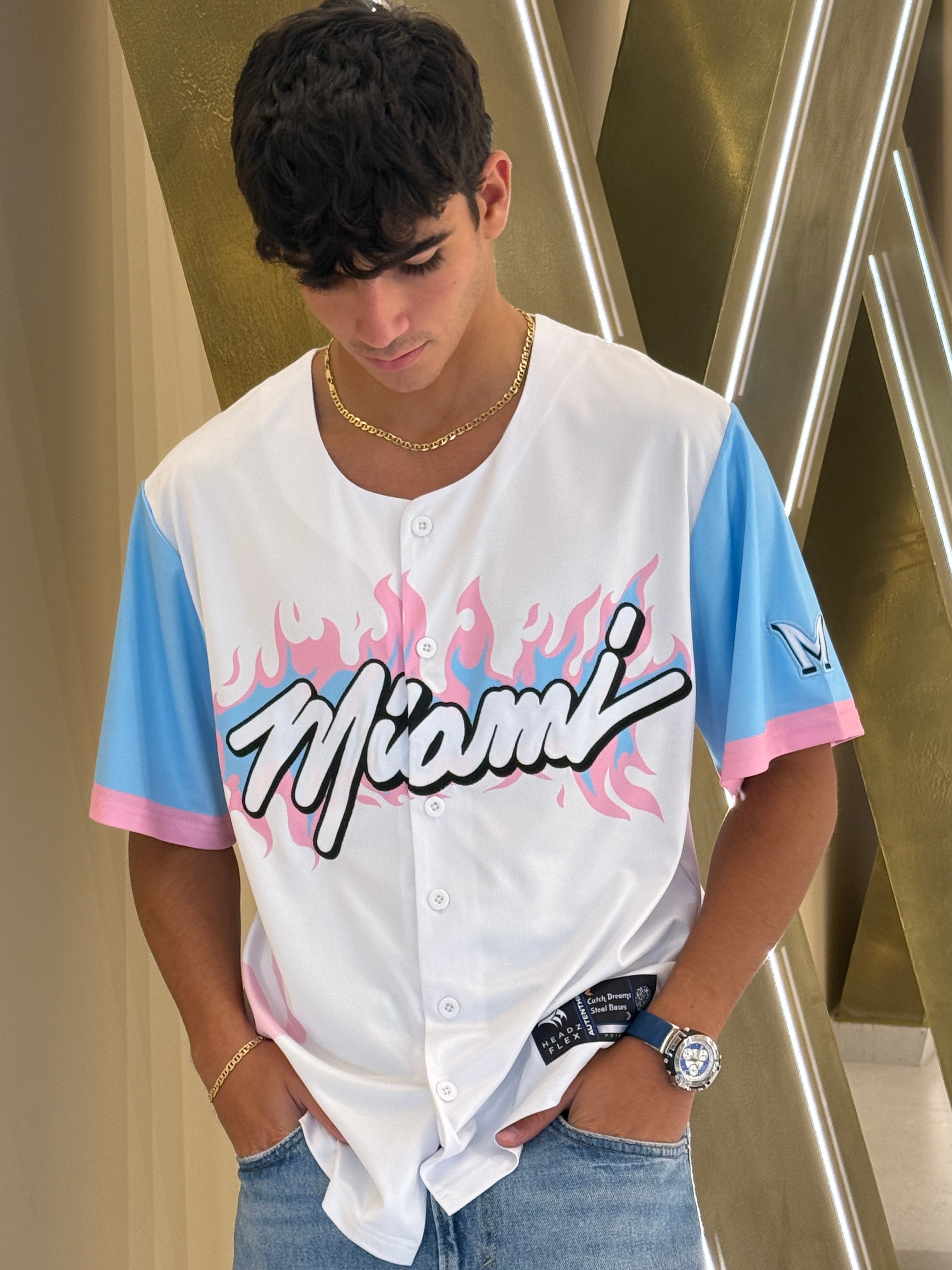 Person wearing a 'Miami' jersey with colorful sleeves on a metallic staircase.