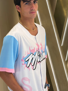 Person wearing a white t-shirt with colorful graphics and text.