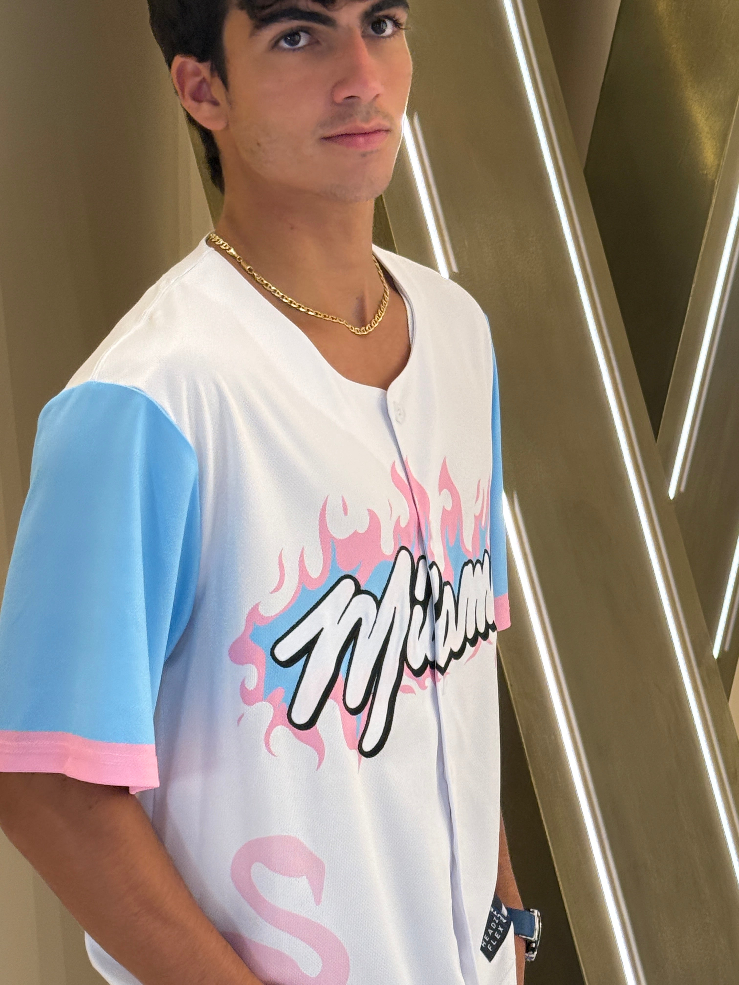 Person wearing a white t-shirt with colorful graphics and text.