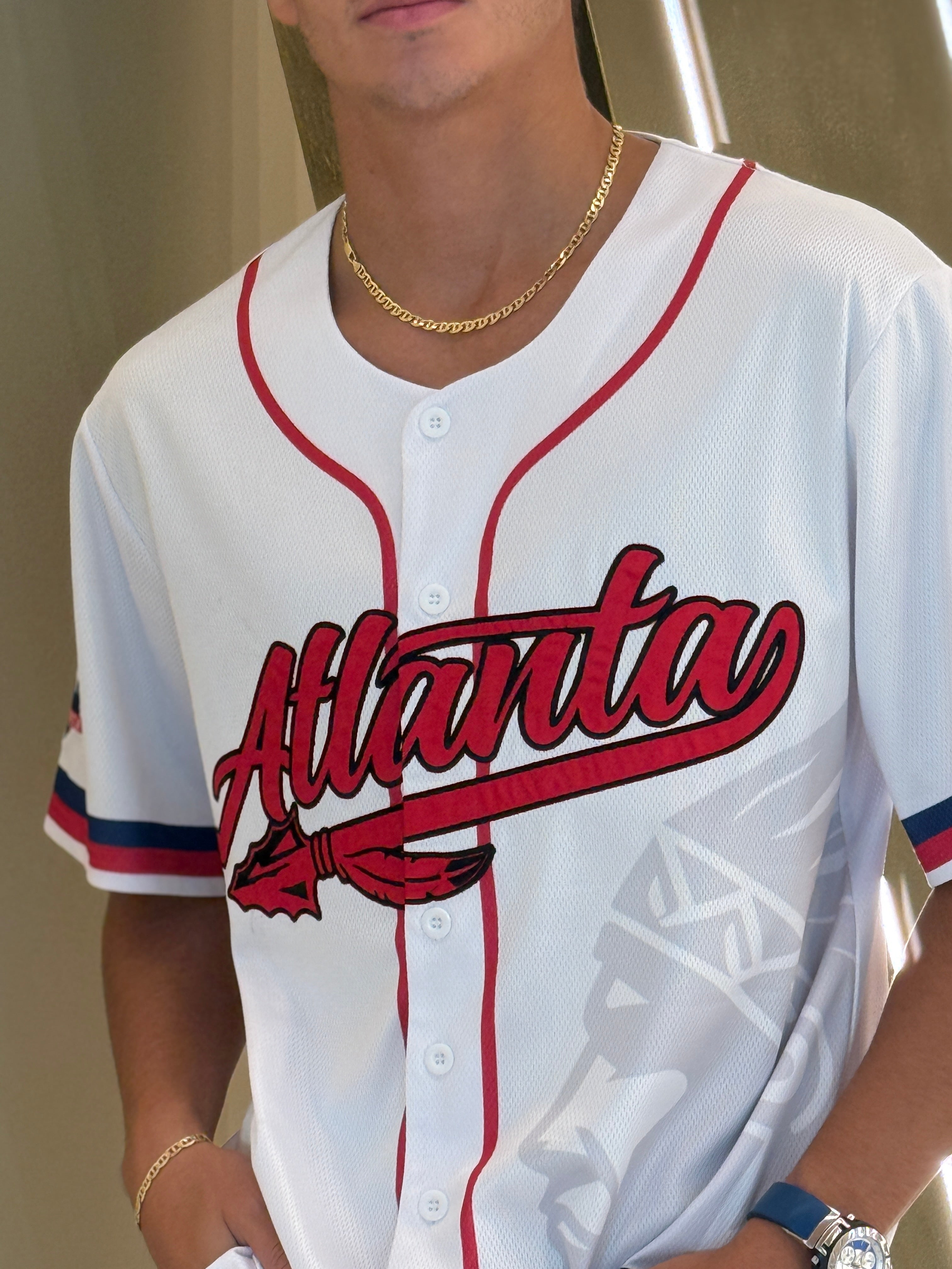 Atlanta baseball jersey 13 - Person wearing a white baseball jersey with red text and accents.