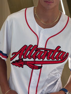 Atlanta baseball jersey 13 - White baseball jersey with red 'Atlanta' text and logo on a neutral background