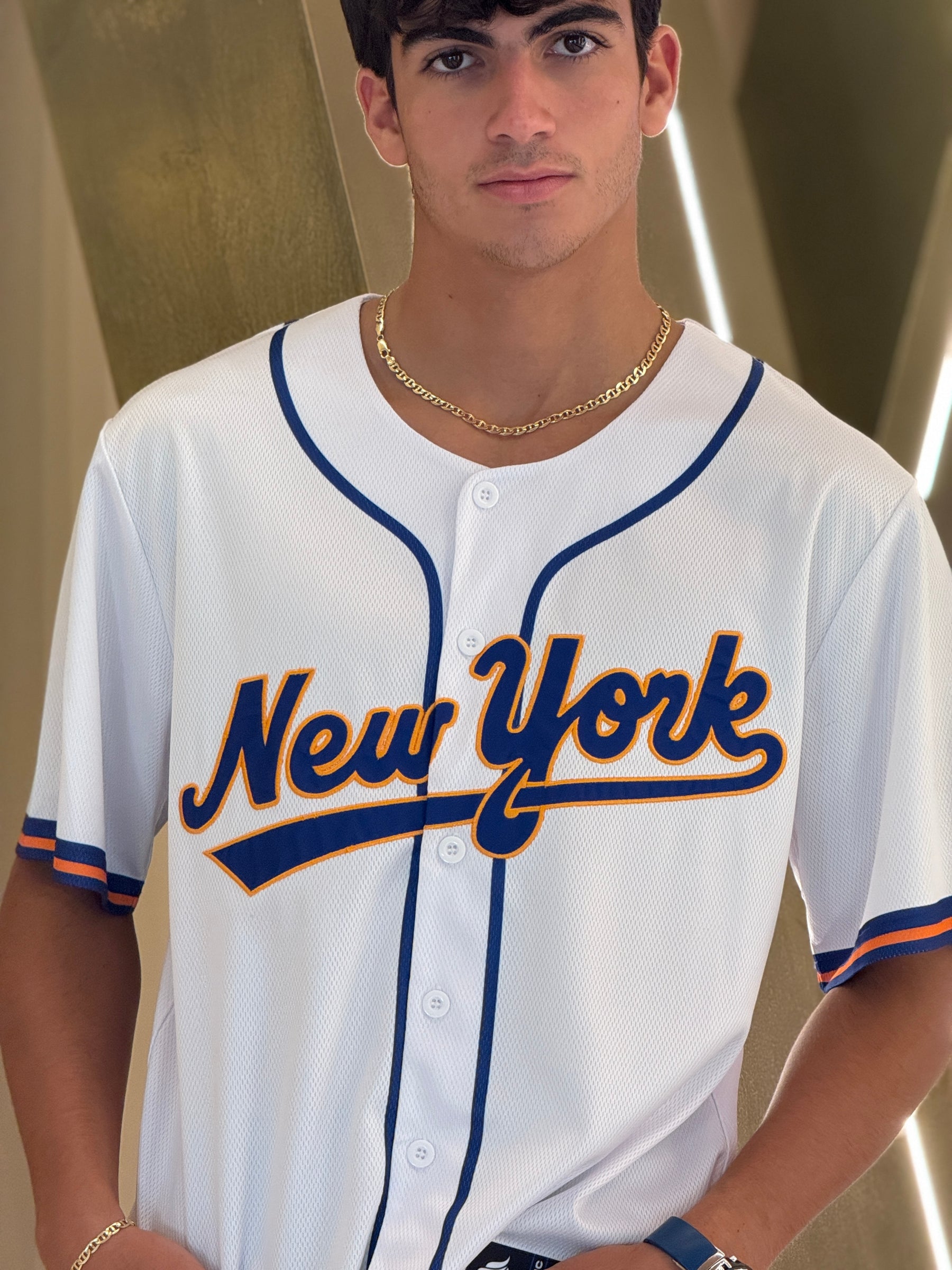 Person wearing a 'New York' baseball jersey indoors