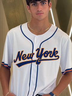 Person wearing a 'New York' baseball jersey indoors