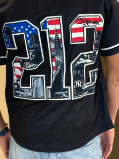 Black t-shirt with '212' design featuring American flag colors and images, worn by a person.