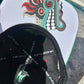 Close-up of Quetzalcoatl art under brim

