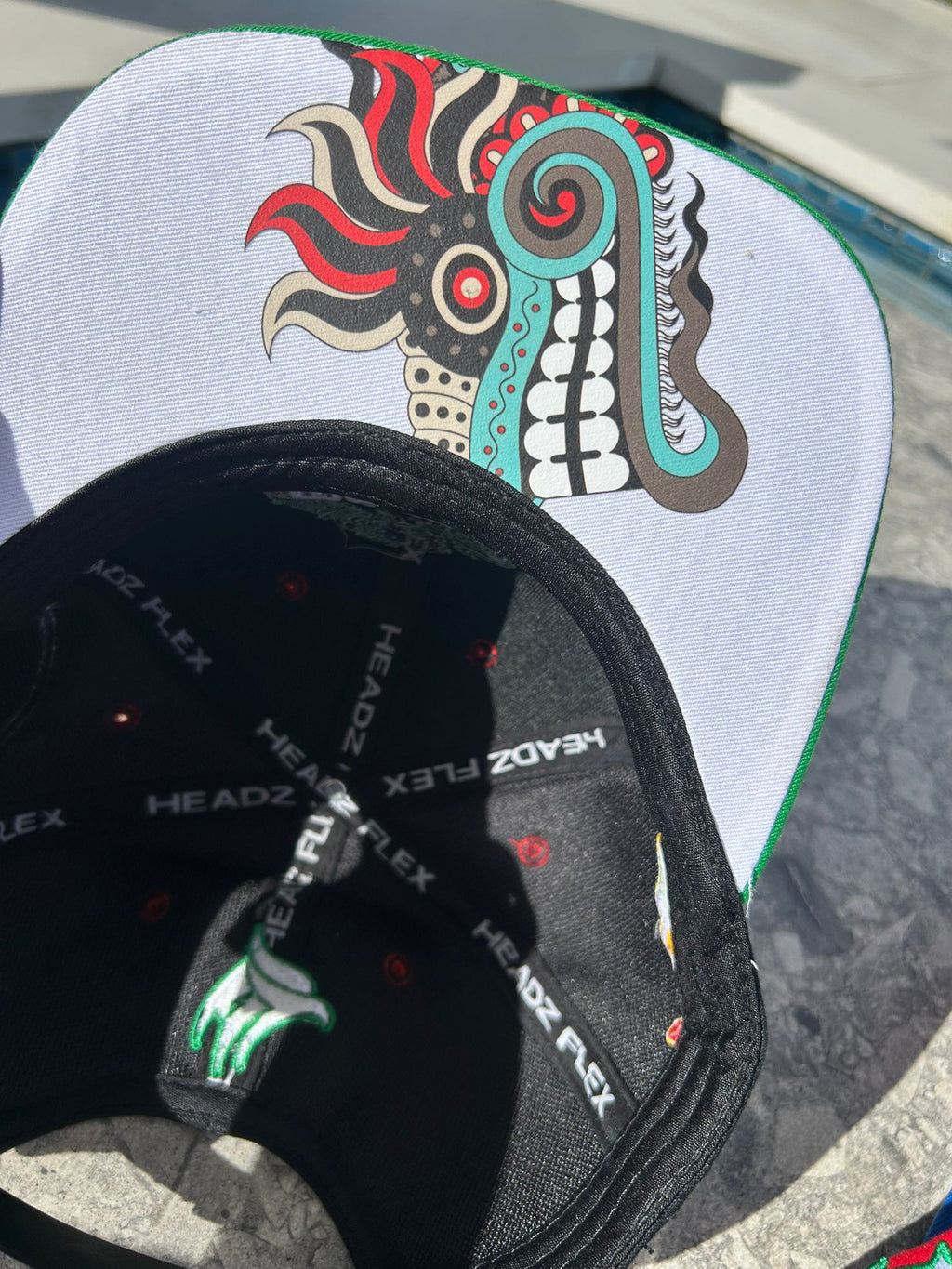Close-up of Quetzalcoatl art under brim

