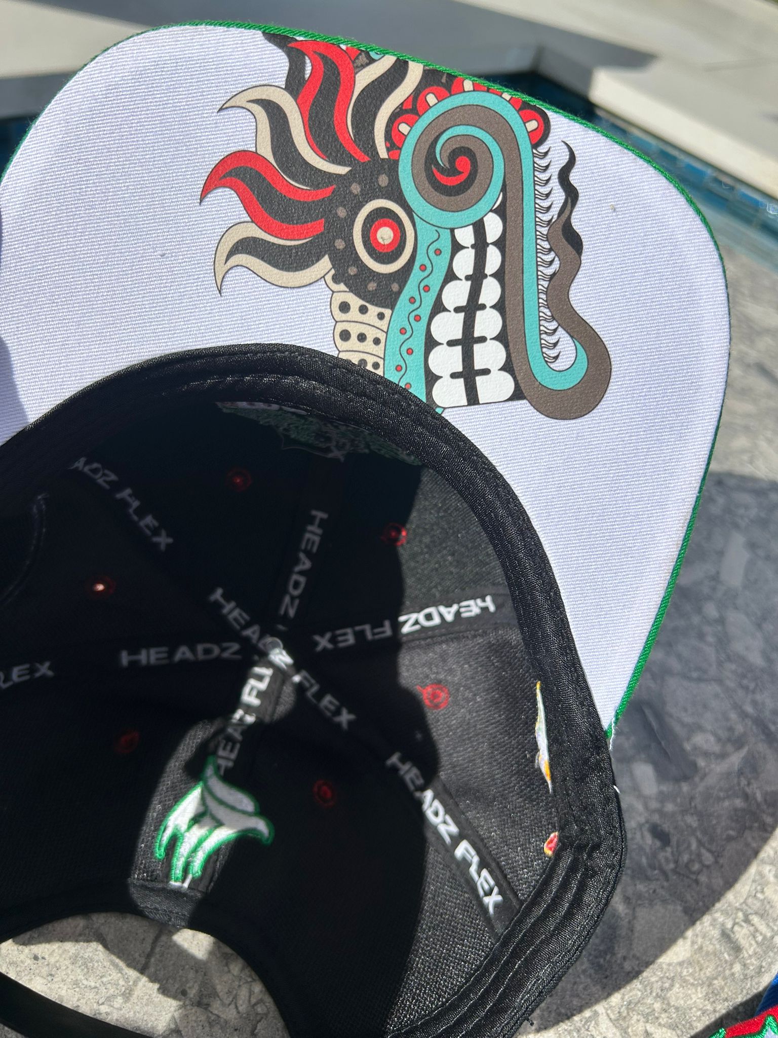 Close-up of Quetzalcoatl art under brim

