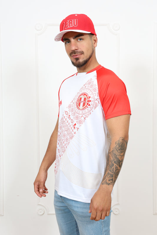 A person wearing a short-sleeved soccer jersey with a red and white design, featuring an embroidered emblem and a silicone patch on the chest.