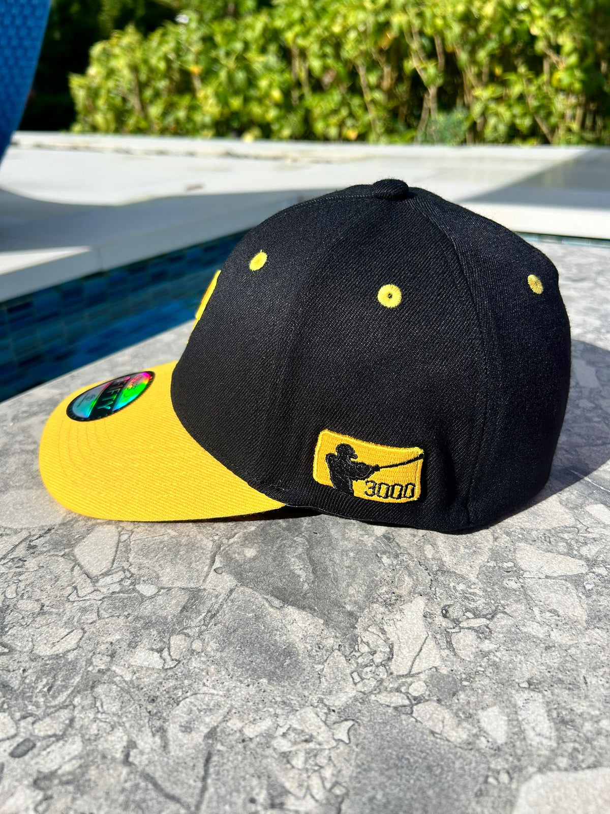 3000 hits patch on side of Clemente baseball cap


