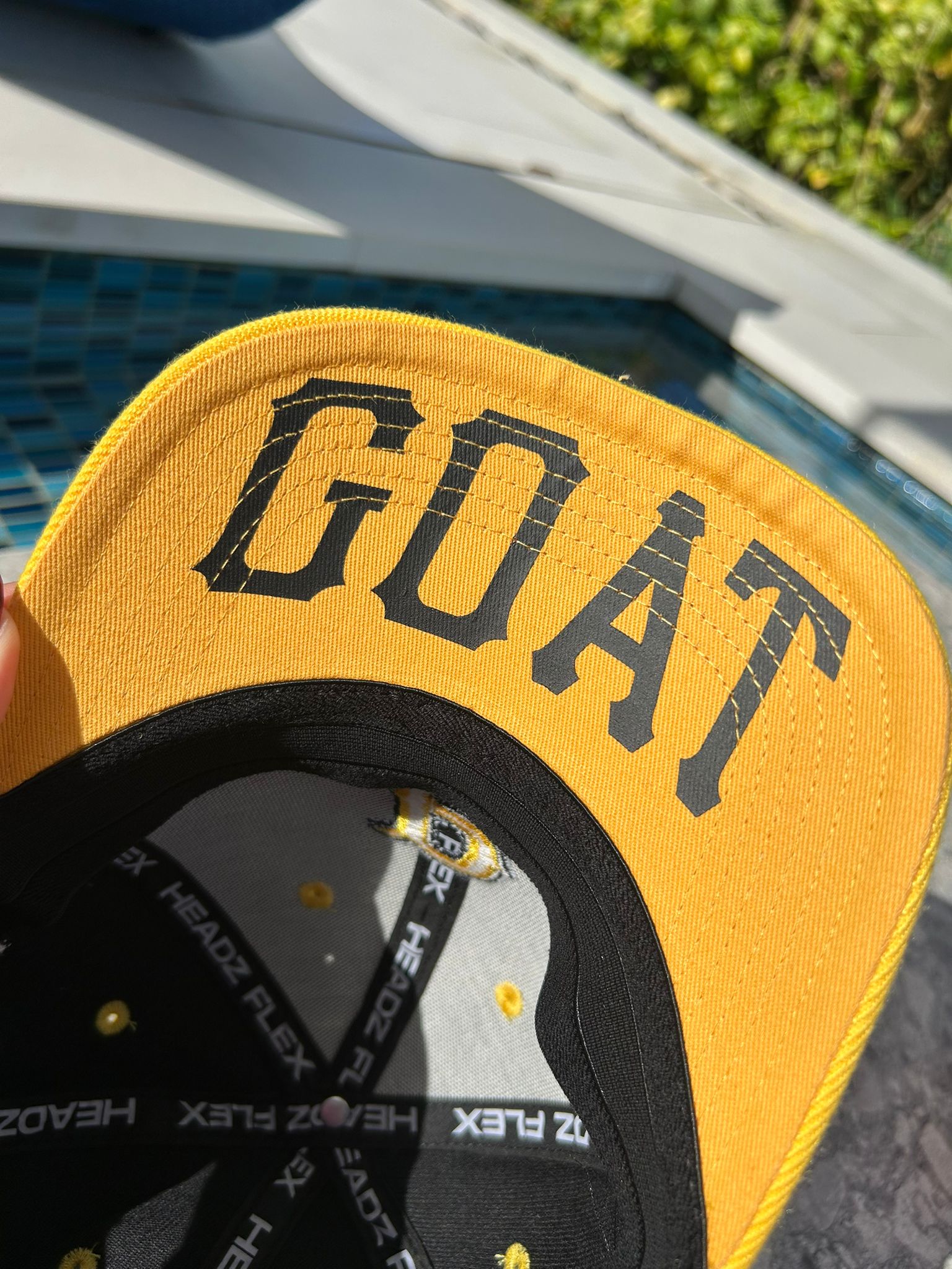 Inside view of GOAT print on Clemente baseball cap

