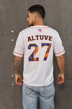A person wearing a white V-neck, short-sleeve baseball jersey with 'ALTUVE 27' embroidered on the back in orange and blue, representing the Houston Astros.