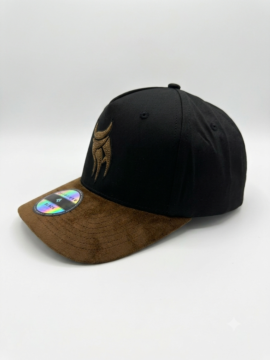 Golden Emblem black and gold snapback hat with brown textured brim, angled front view