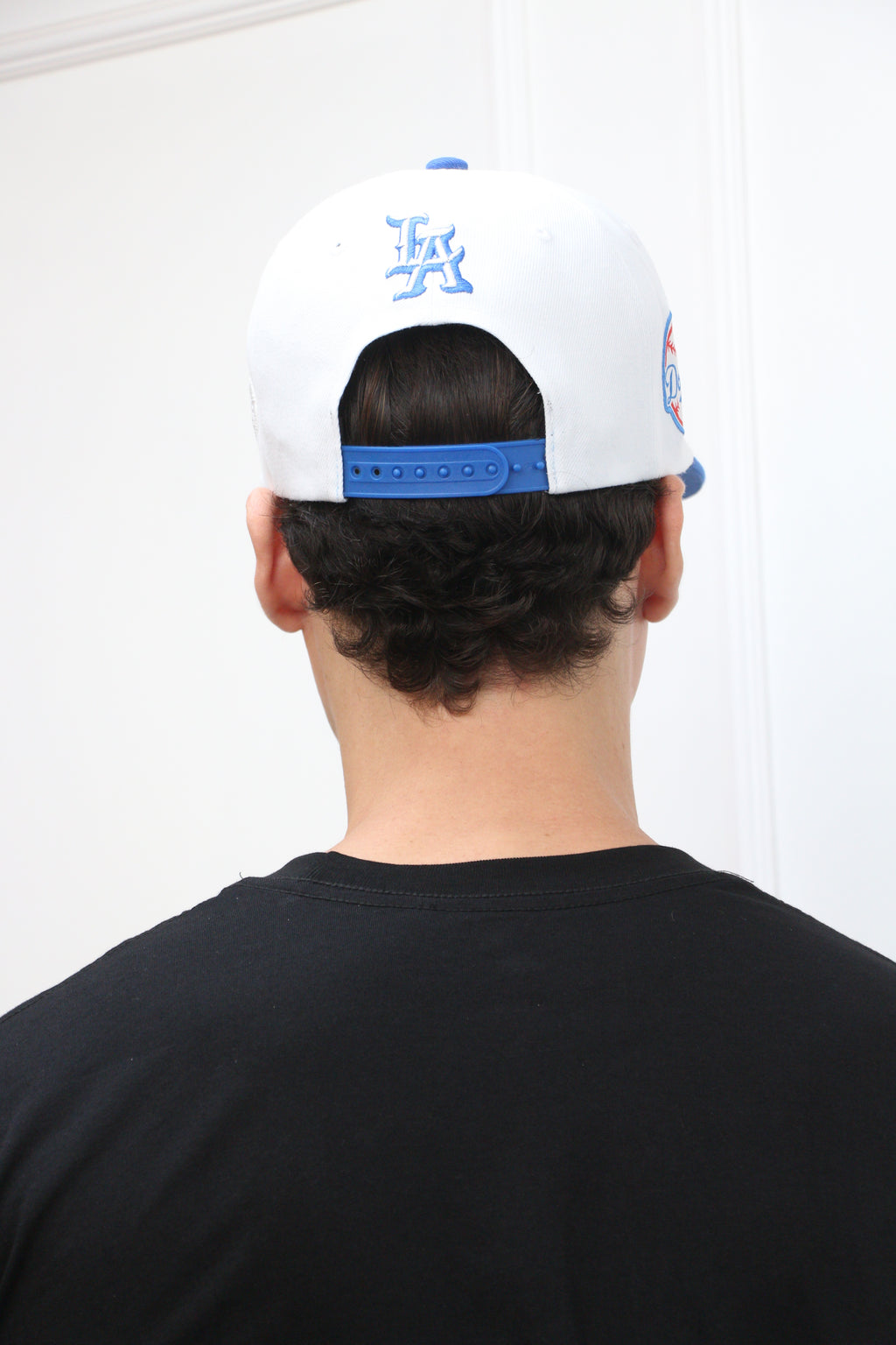 Back of snapback hat with adjustable strap

