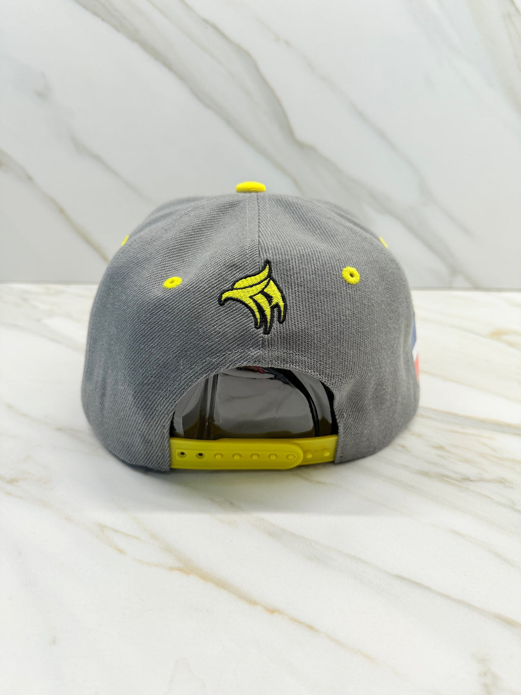 Gray Águilas Cibaeñas Snapback Cap back view with yellow strap and embroidery

