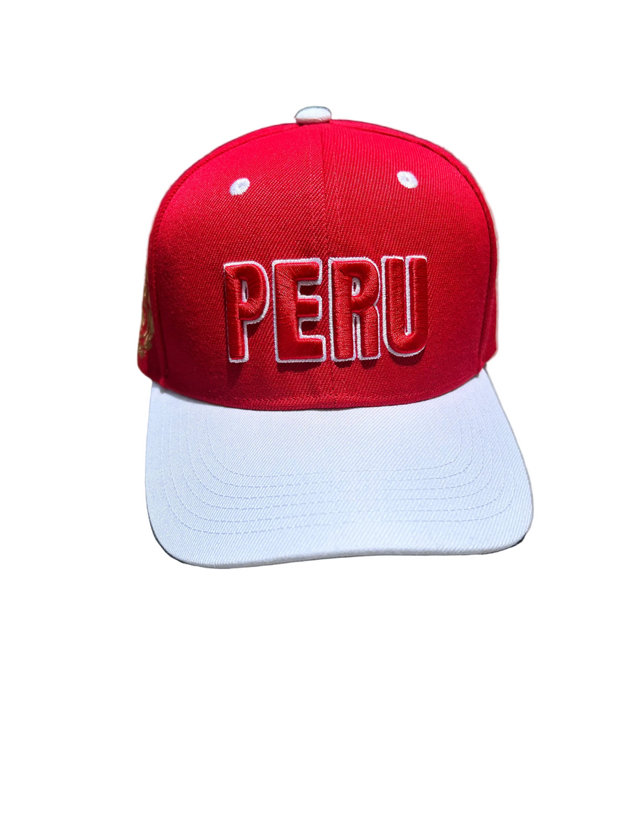 A red and white baseball cap with 'PERU' embroidered in 3D on the front and the Coat of Arms of Peru on the sides, displayed on a flat surface.