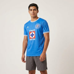 Man wearing a blue sports jersey with a logo on a white background