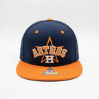 Navy and orange Houston Astros cap on a white background