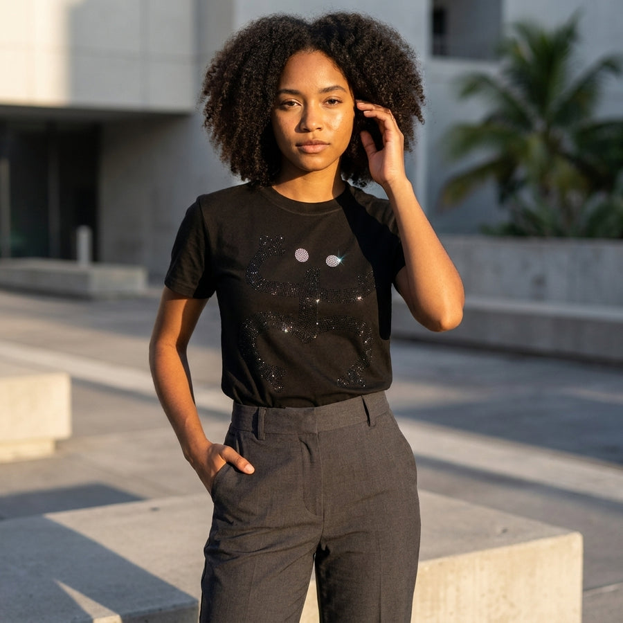 Person wearing a black t-shirt with graphics outdoors