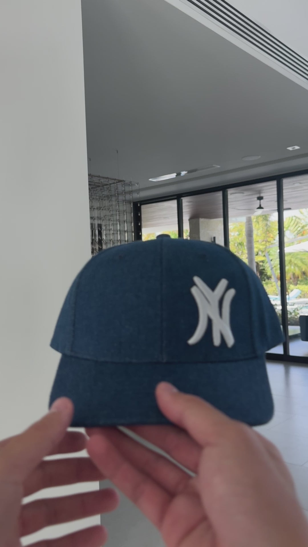 Video: New York denim snapback cap shown in hand, front view of raised NY embroidery